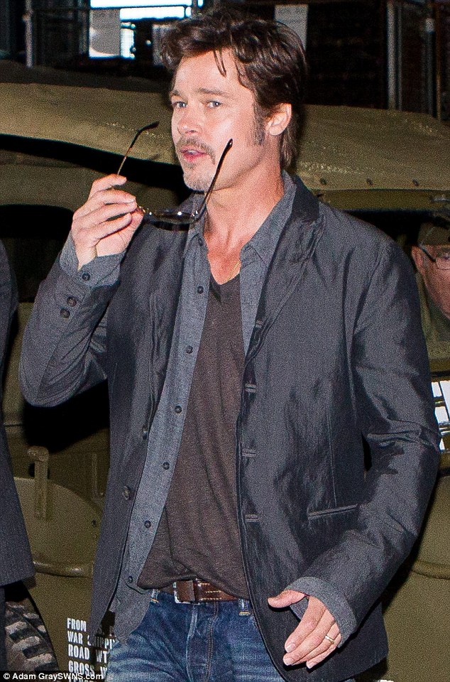 There it is! Brad sports his wedding ring at a photocall for Fury on Thursday in Dorset, having married his fiancée Angelina Jolie over the weekend